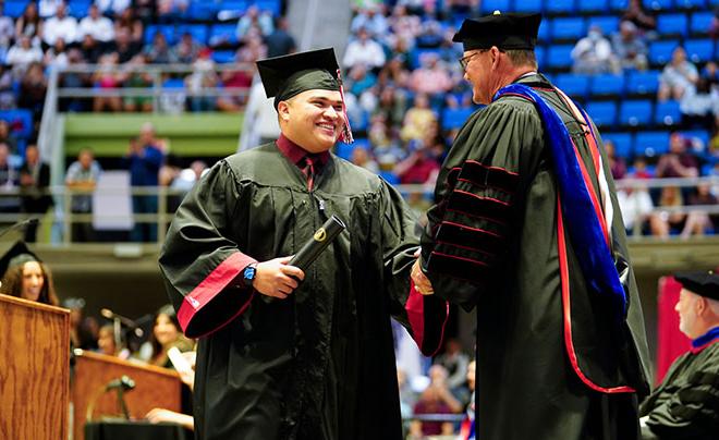 Graduate shaking Dr. Evans's hand